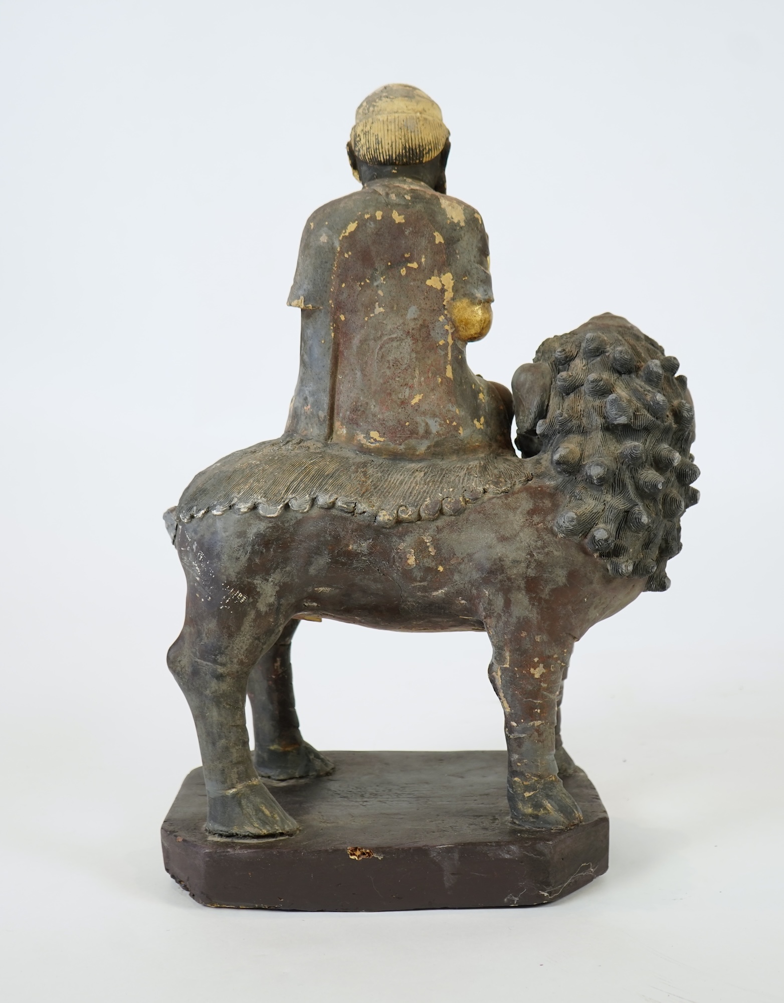 A Chinese gilt and polychrome lacquered stucco work and wood figure of Manjushri on a lion, Yuan-Ming dynasty